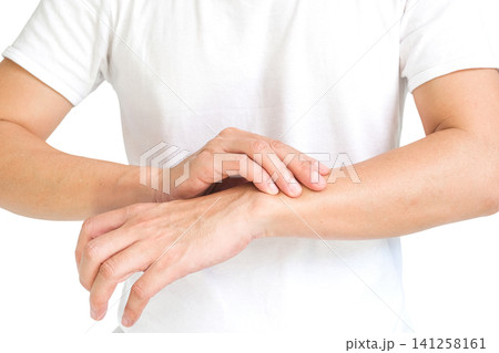 The man touches the wrist and thumb. He squeezes the knuckle of the thumb and wrist. He suffered a tendon injury, arthritis in his wrist, and de quervain's disease. The man touches the wrist and thumb. He squeezes the knuckle of the thumb and wrist. He suffered a tendon injury, arthritis in his wrist, and de quervain's disease. 141258161