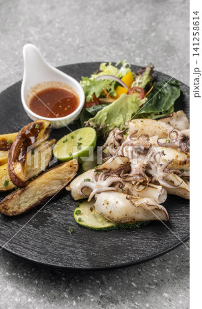 mediterranean grilled fresh squid meal on restaurant table mediterranean grilled fresh squid meal on restaurant table 141258614