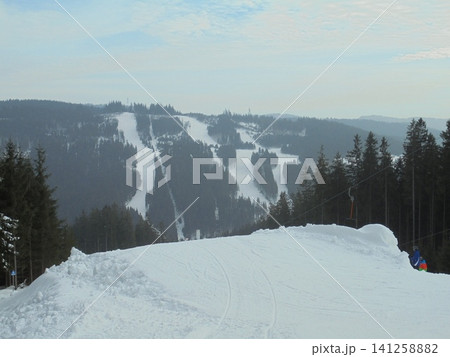 Magnificent winter landscape in Beskydy in Czechia with snow-covered hill Magnificent winter landscape in Beskydy in Czechia with snow-covered hill 141258882