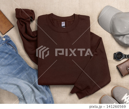 Blank brown unisex sweatshirt mockup, folded crewneck with mens accessories and sneakers 141260569