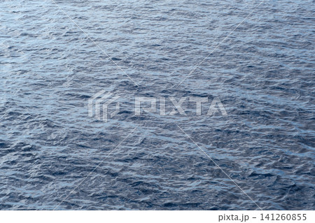 Smooth blue ocean water surface with subtle waves, reflecting natural light and creating a peaceful aquatic environment Smooth blue ocean water surface with subtle waves, reflecting natural light and creating a peaceful aquatic environment 141260855