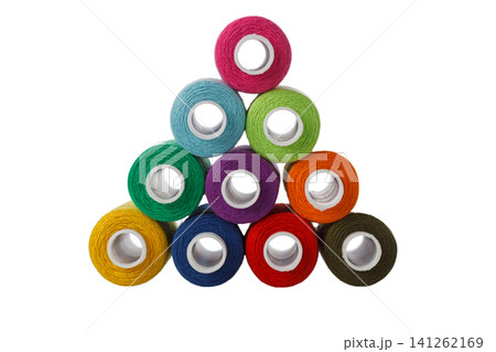 multi-colored spools of sewing thread in the form of a pyramid on a white background multi-colored spools of sewing thread in the form of a pyramid on a white background 141262169
