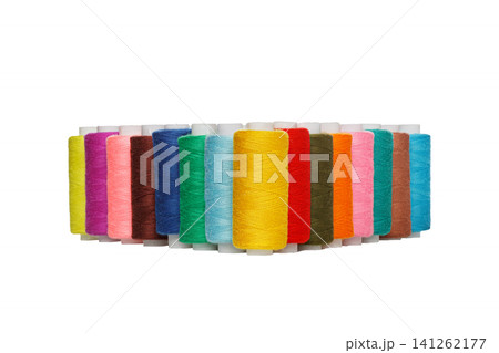 multi-colored spools of sewing thread on a white background multi-colored spools of sewing thread on a white background 141262177
