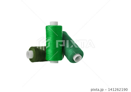 green spool of sewing thread isolated on white background green spool of sewing thread isolated on white background 141262190