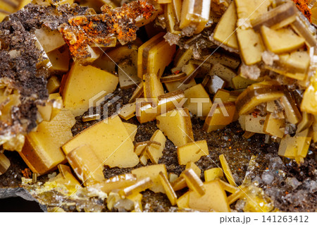 Macro mineral stone yellow Wulfenite on a white background Macro mineral stone yellow Wulfenite on a white background 141263412