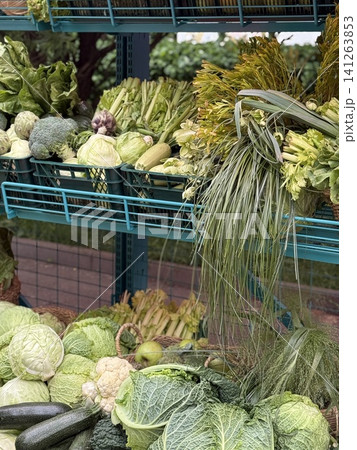Fresh green vegetables displayed on market stand, vibrant display for healthy food background Fresh green vegetables displayed on market stand, vibrant display for healthy food background 141263853