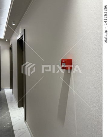 Fire alarm on white ceiling in modern building interior with natural light from windows Fire alarm on white ceiling in modern building interior with natural light from windows 141263866