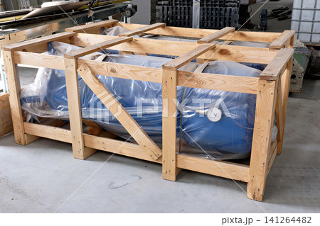 New blue industrial pressure receiver tank packed in protective wooden crate box crate New blue industrial pressure receiver tank packed in protective wooden crate box crate 141264482