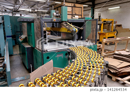 Automated industrial strapping machine and flexible roller conveyor line in manufacturing warehouse Automated industrial strapping machine and flexible roller conveyor line in manufacturing warehouse 141264534