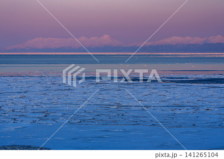 北海道網走から見る夕焼けに染まる流氷と羅臼岳を主峰とする知床連山 冬の絶景観光素材 北海道網走から見る夕焼けに染まる流氷と羅臼岳を主峰とする知床連山 冬の絶景観光素材 141265104
