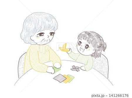 孫と一緒にテーブルで楽しく折り紙をして遊ぶシニアの女性 141266176