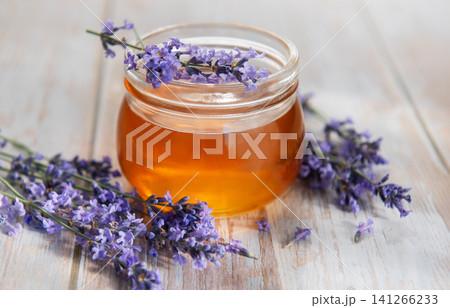 Lavender honey jar with fresh flowers on wood Lavender honey jar with fresh flowers on wood 141266233