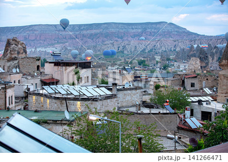 Hot air balloons rise over Cappadocia as buildings and landscape are visible at dawn in Turkey. 05.11.2018. Cappadocia. Turkey Hot air balloons rise over Cappadocia as buildings and landscape are visible at dawn in Turkey. 05.11.2018. Cappadocia. Turkey 141266471