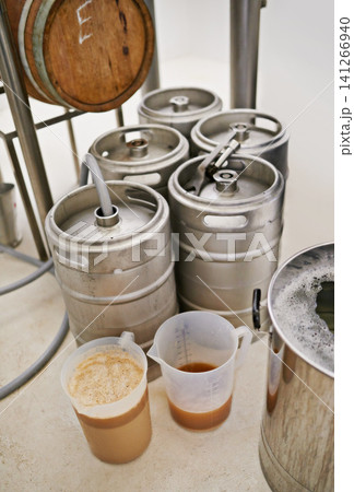 Brewery, tank and craft beer in container for production with manufacturing process, distillation and alcohol in jug. Industrial industry, closeup and brewing drum in factory, warehouse or distillery Brewery, tank and craft beer in container for production with manufacturing process, distillation and alcohol in jug. Industrial industry, closeup and brewing drum in factory, warehouse or distillery 141266940
