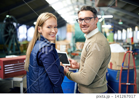 Man, woman and tablet in factory for team management in export business, check emails and delivery. Male person, portrait and female employee with technology for warehouse inventory or stock. 141267017