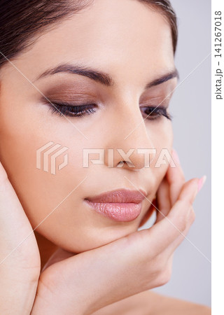 Woman, face and hand with beauty and skincare, dermatology and eyeshadow for cosmetics isolated on white background. Makeup, transformation and healthy glow for skin, wellness and self care in studio 141267018