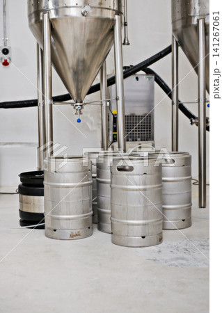 Steel tank, keg and beer production at brewery with equipment for process, factory and storage with craft drink. Alcohol, metal container and industrial machine, brewing system and manufacturing Steel tank, keg and beer production at brewery with equipment for process, factory and storage with craft drink. Alcohol, metal container and industrial machine, brewing system and manufacturing 141267061