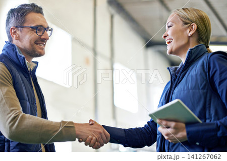 Greeting, deal and business people with handshake for partnership, distribution or agreement. Professional, tablet and shaking hands for export support, b2b networking or welcome in shipping facility Greeting, deal and business people with handshake for partnership, distribution or agreement. Professional, tablet and shaking hands for export support, b2b networking or welcome in shipping facility 141267062