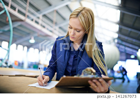 Business people, writing and reading with inventory checklist for clipboard, storage or supply chain at warehouse. Female person or employee with documents or paperwork for distribution at factory Business people, writing and reading with inventory checklist for clipboard, storage or supply chain at warehouse. Female person or employee with documents or paperwork for distribution at factory 141267073