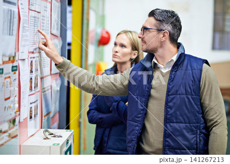 People, planning and checking schedule with board in warehouse with calendar for order details. Man, woman and together with checklist or clipboard for supplier information and inventory updates People, planning and checking schedule with board in warehouse with calendar for order details. Man, woman and together with checklist or clipboard for supplier information and inventory updates 141267213