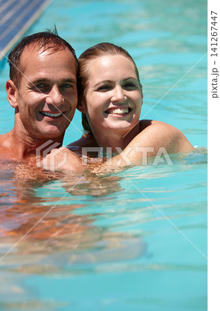 Couple, portrait and hug with love in swimming pool for connection, care and relax on vacation for honeymoon. Man, woman and embrace in water for smile, bonding or summer holiday at resort in Naples Couple, portrait and hug with love in swimming pool for connection, care and relax on vacation for honeymoon. Man, woman and embrace in water for smile, bonding or summer holiday at resort in Naples 141267447