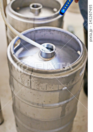Brewery, container and pipe in machine for production with manufacturing process, distillation and craft beer in keg. Industrial industry, closeup and brewing tank in factory, warehouse or distillery 141267495