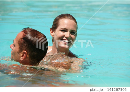 Couple, swimming pool and smile for summer or vacation on honeymoon for marriage, fun or laugh and sunshine. Man and woman in water and together on holiday in resort, happy or break or weekend Couple, swimming pool and smile for summer or vacation on honeymoon for marriage, fun or laugh and sunshine. Man and woman in water and together on holiday in resort, happy or break or weekend 141267503