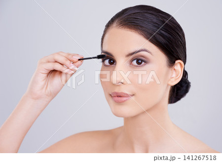 Makeup, mascara and brush with woman in portrait, beauty for lashes and cosmetology on white background. Skin, glow and transformation for makeover, cosmetic product and wand for eyelash with volume 141267518