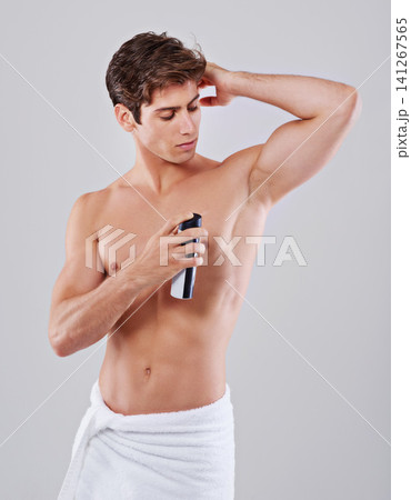 Underarm, deodorant and man on a white background for fragrance, hygiene and fresh scent for health. Skincare, perfume and isolated person with muscle for grooming, self care and wellness in studio 141267565
