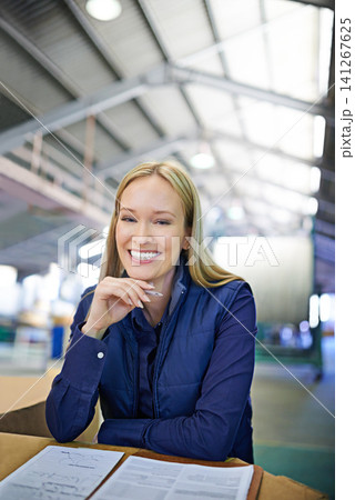 Portrait, supervisor and happy as businesswoman in logistics at factory with machines for supply chain. Woman, warehouse and table with paperwork in manufacturing and distribution business with smile Portrait, supervisor and happy as businesswoman in logistics at factory with machines for supply chain. Woman, warehouse and table with paperwork in manufacturing and distribution business with smile 141267625