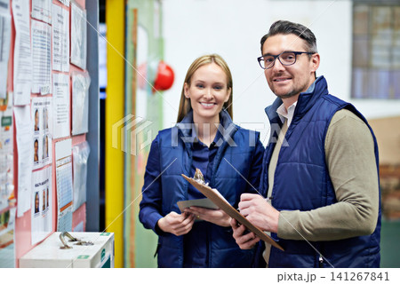 Warehouse, clipboard and portrait of business people with smile for collaboration, compliance and inspection. Billboard, woman and man with checklist for report, teamwork and factory information 141267841