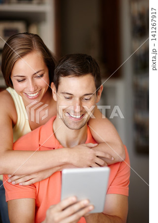 Couple, hug and happy in home with tablet for streaming online for movies or films, videos and social media memes. Man, woman and together with hug for bonding or love with affection and support Couple, hug and happy in home with tablet for streaming online for movies or films, videos and social media memes. Man, woman and together with hug for bonding or love with affection and support 141267917