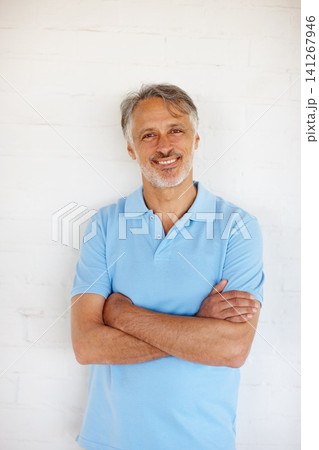 Portrait, arms crossed and smile of mature man on brick wall for fashion isolated on white background in Switzerland. Face, confidence and happy person in casual clothes, shirt and positive for style 141267946