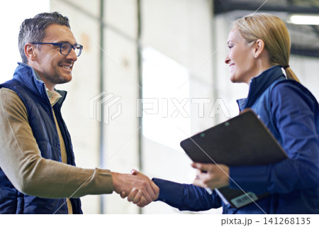 Business people, handshake and welcome for partnership, collaboration and agreement. Professional, clipboard and shaking hands for introduction, b2b onboarding or teamwork in shipping warehouse Business people, handshake and welcome for partnership, collaboration and agreement. Professional, clipboard and shaking hands for introduction, b2b onboarding or teamwork in shipping warehouse 141268135