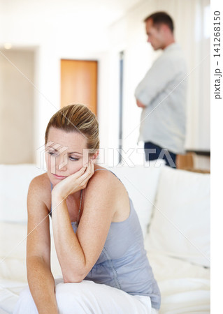 Divorce, thinking and woman in home for conflict, crisis or fight in living room. Couple, breakup and sad people with depression, anger or frustrated with stress in argument for marriage fail on sofa Divorce, thinking and woman in home for conflict, crisis or fight in living room. Couple, breakup and sad people with depression, anger or frustrated with stress in argument for marriage fail on sofa 141268150