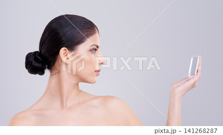 Woman, beauty and cosmetic with compact mirror, confidence and pride for dermatology, skin and health. Female person, face and wellness in studio, background and clean for pure, skincare and makeup Woman, beauty and cosmetic with compact mirror, confidence and pride for dermatology, skin and health. Female person, face and wellness in studio, background and clean for pure, skincare and makeup 141268287