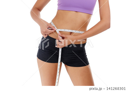 Health, fitness and woman with measuring tape for waist, weight goal with diet and exercise on white background. Stomach, body and wellness, check progress for weightloss and measurement in studio Health, fitness and woman with measuring tape for waist, weight goal with diet and exercise on white background. Stomach, body and wellness, check progress for weightloss and measurement in studio 141268301