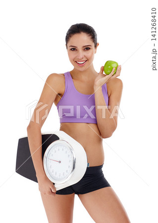 Portrait, scale and woman with wellness, apple and healthy person isolated on a white studio background. Face, happy girl and model with smile and exercise with diet plan and weight loss with fruit Portrait, scale and woman with wellness, apple and healthy person isolated on a white studio background. Face, happy girl and model with smile and exercise with diet plan and weight loss with fruit 141268410
