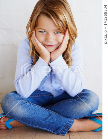 Portrait, children and girl in house happy, calm or chilling on a floor alone on the weekend against wall background. Child development, youth and face of curious kid relax at home while daydreaming 141268534