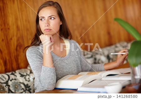 Woman, thinking and home with textbook to study for university exams or test and reading notes. female person, college and student in living room or lounge for distance learning and revision. 141268580