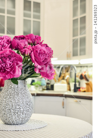 Pink peony bouquet in a kitchen interior Pink peony bouquet in a kitchen interior 141269323