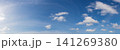 Wide angle panorama of beautiful sky with cumulus clouds  over a clear horizon. 141269380