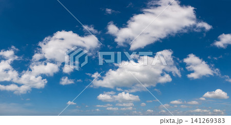 Wide angle panorama of beautiful sky with cumulus clouds  over a clear horizon. 141269383