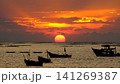 Dramatic sunset over the ocean horizon, colorful sky reflecting on the sea water. 141269387