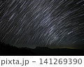 Starry night over mountain long exposure of star trail in dark night sky. 141269390