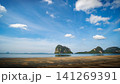 Beautiful sunny day at a tropical beach, white clouds drifting over the turquoise sea. 141269391