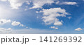 Wide angle panorama of beautiful sky with cumulus clouds  over a clear horizon. 141269392