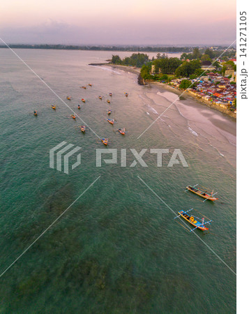 Sunset beach in Indonesia with golden waves and pristine white sand capturing tropical beauty and serene coastal atmosphere Sunset beach in Indonesia with golden waves and pristine white sand capturing tropical beauty and serene coastal atmosphere 141271105