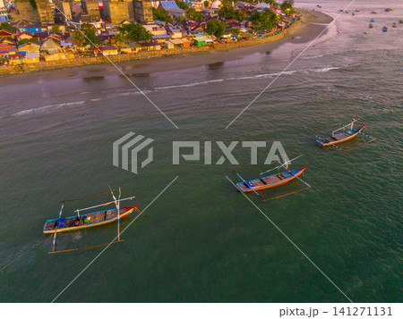 Sunset beach in Indonesia with golden waves and pristine white sand capturing tropical beauty and serene coastal atmosphere 141271131