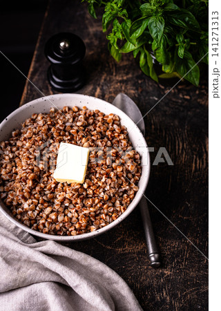 Buckwheat porridge with butter in a white bowl Buckwheat porridge with butter in a white bowl 141271313